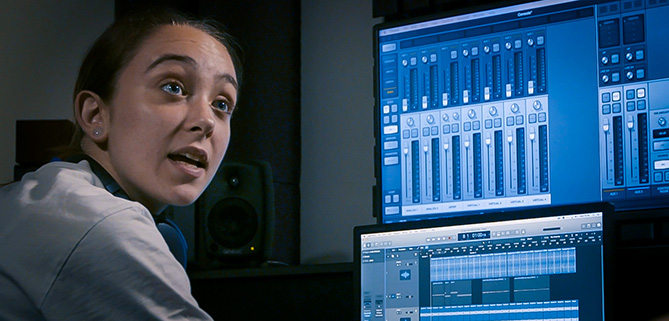 A young woman mixes music digitally