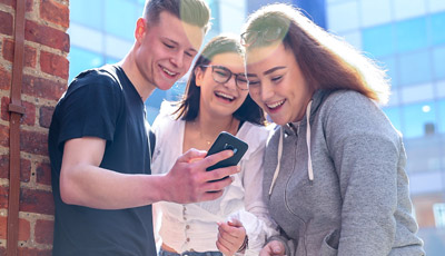 A group of students looking at a phone